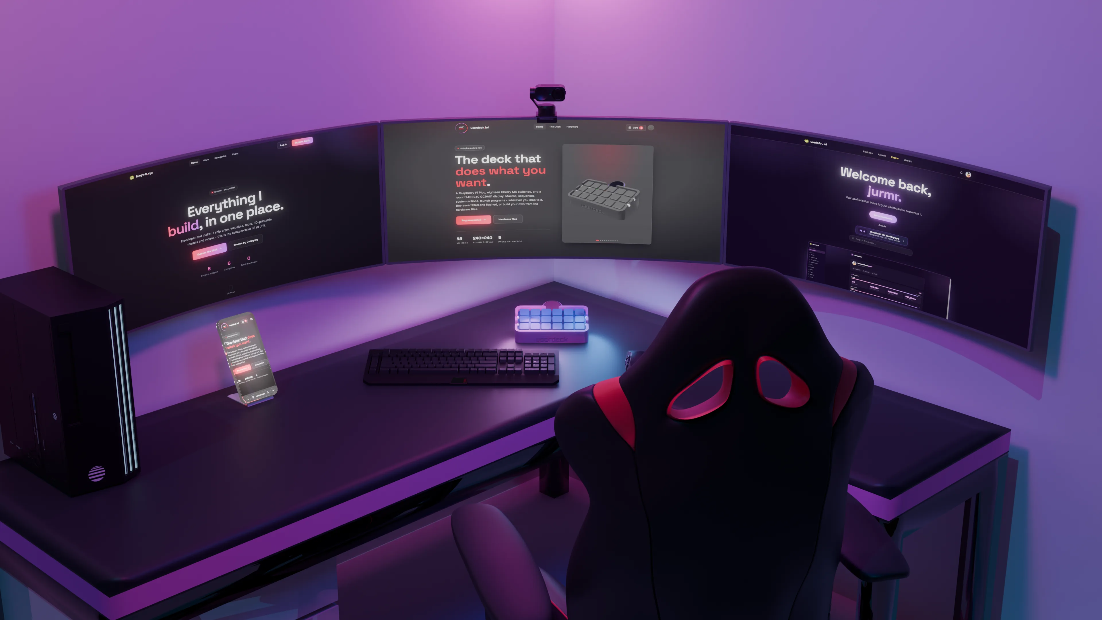 The userdeck on a desk in front of a triple-monitor battlestation showing the userdeck site